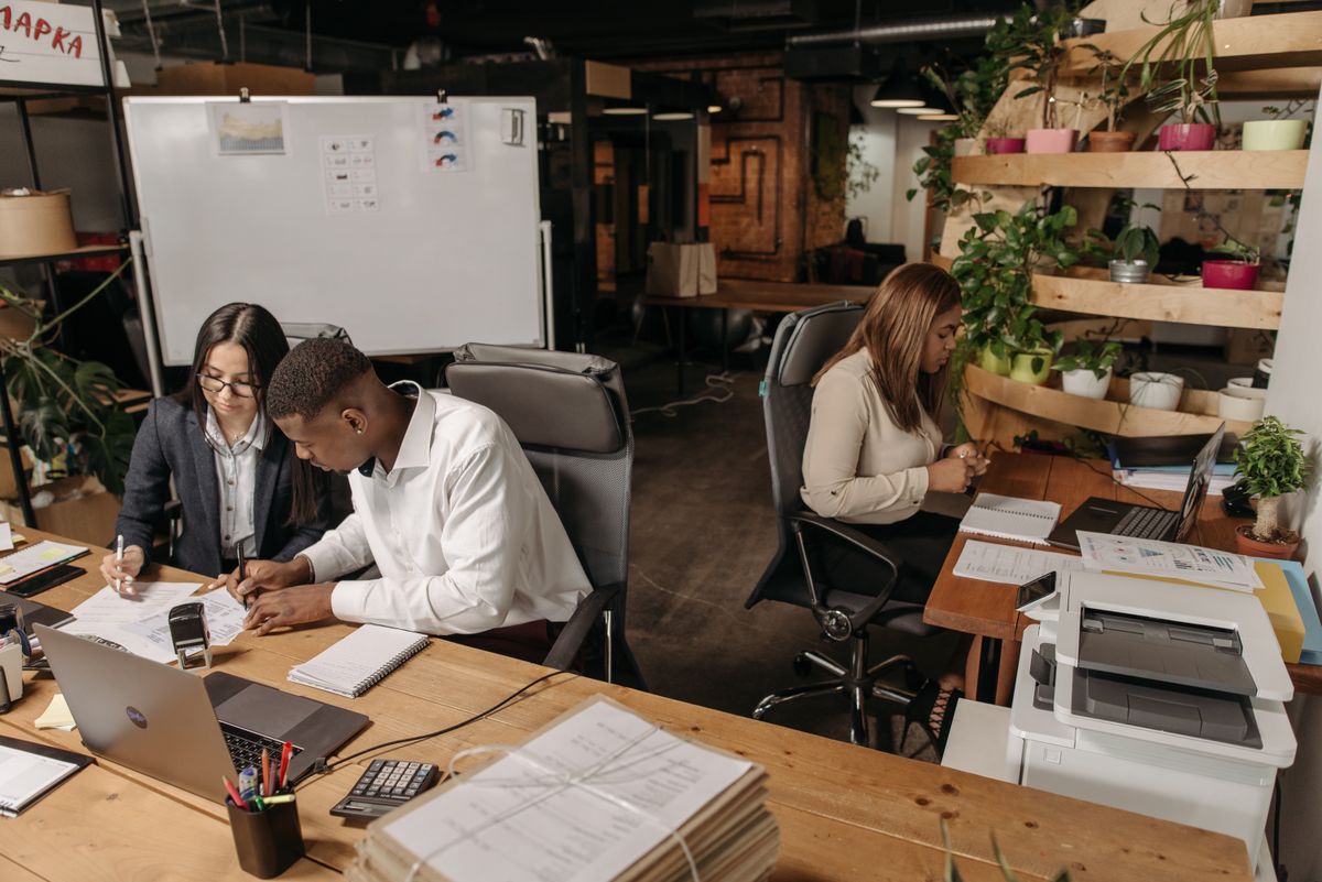 Colleagues working together on documents in a shared office