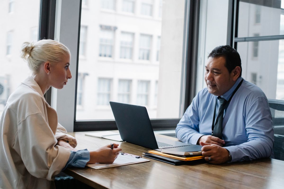 A hiring interview taking place at an office desk