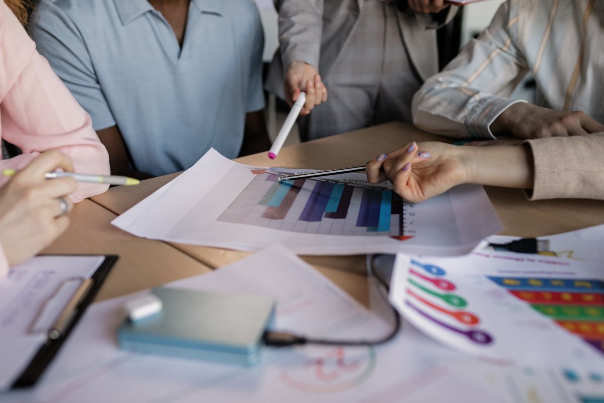 Colleagues reviewing campaign charts and reports in a meeting