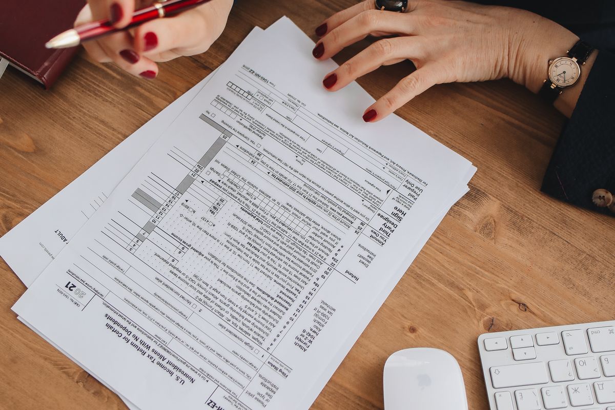 A professional reviewing U.S. tax return forms at a desk