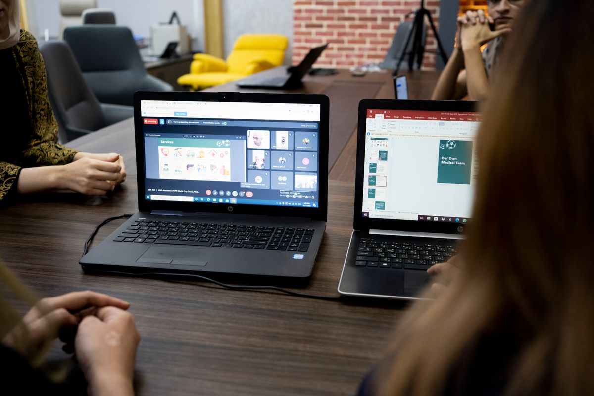 A local team collaborating with remote colleagues through a video meeting